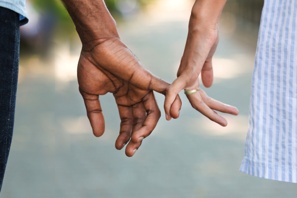 couple holding pinky fingers